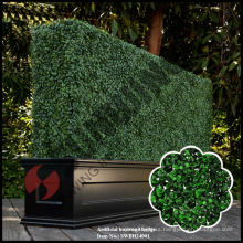 Artificial topiary boxwood hedge with planter